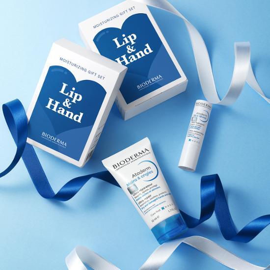 Gift set featuring Bioderma Atoderm Lipstick (4g) and Hand Cream (50ml) for nourishing lip and hand care.
