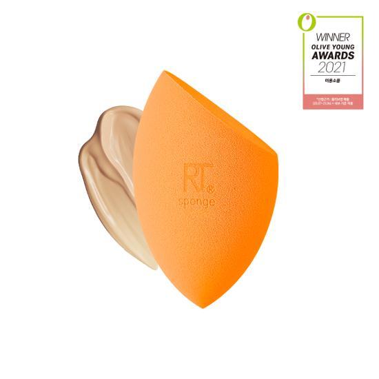 Real Techniques Miracle Complexion Sponge in vibrant orange, designed for flawless makeup application, perfect for blending foundation and concealer.