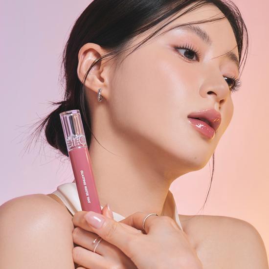 Romand Glasting Water Tint in shade 17 Woody Sunset, showcasing a vibrant, glossy lip color in a sleek tube.