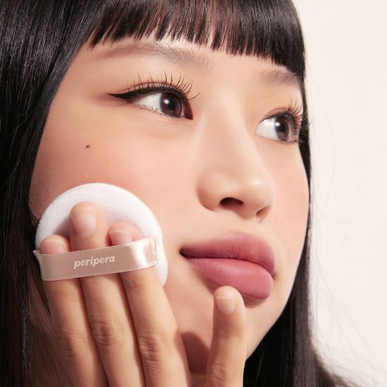 Peripera Oil Capture Cooling Powder in sleek packaging for a matte finish, ideal for oil control and a refreshing look.