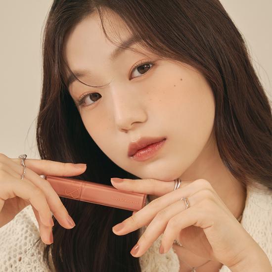 Romand Dewyful Water Tint in shade 09 Cotton Melba, featuring a soft peach hue in a sleek tube.