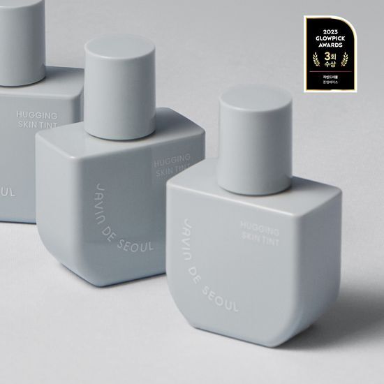 Javinde Seoul Hugging Skin Tint in Airy Tan shade, showcasing a sleek bottle design for a lightweight, natural finish.