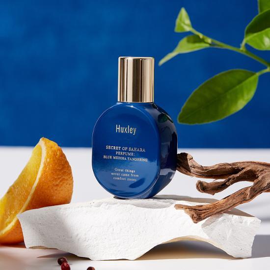 15ml bottle of Huxley Blue Medina Tangerine perfume, a refreshing K-Beauty fragrance in a sleek design.