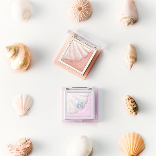 Holika Holika Shell Glow Highlighter in shade 01 Aurora Nacre, featuring a shimmering, iridescent finish for a radiant glow.