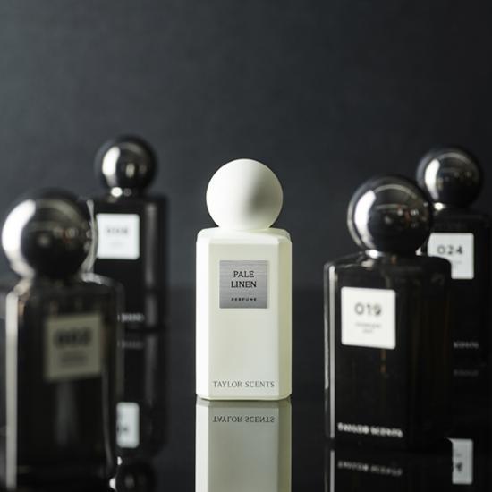 Alt text: Taylor Scent EDP 50ml in a sleek pale linen bottle, representing a refined fragrance for personal care.
