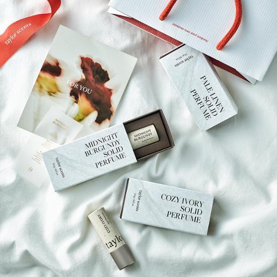 Taylor Scent Solid Perfume available in three options, featuring a sleek design ideal for on-the-go fragrance application.